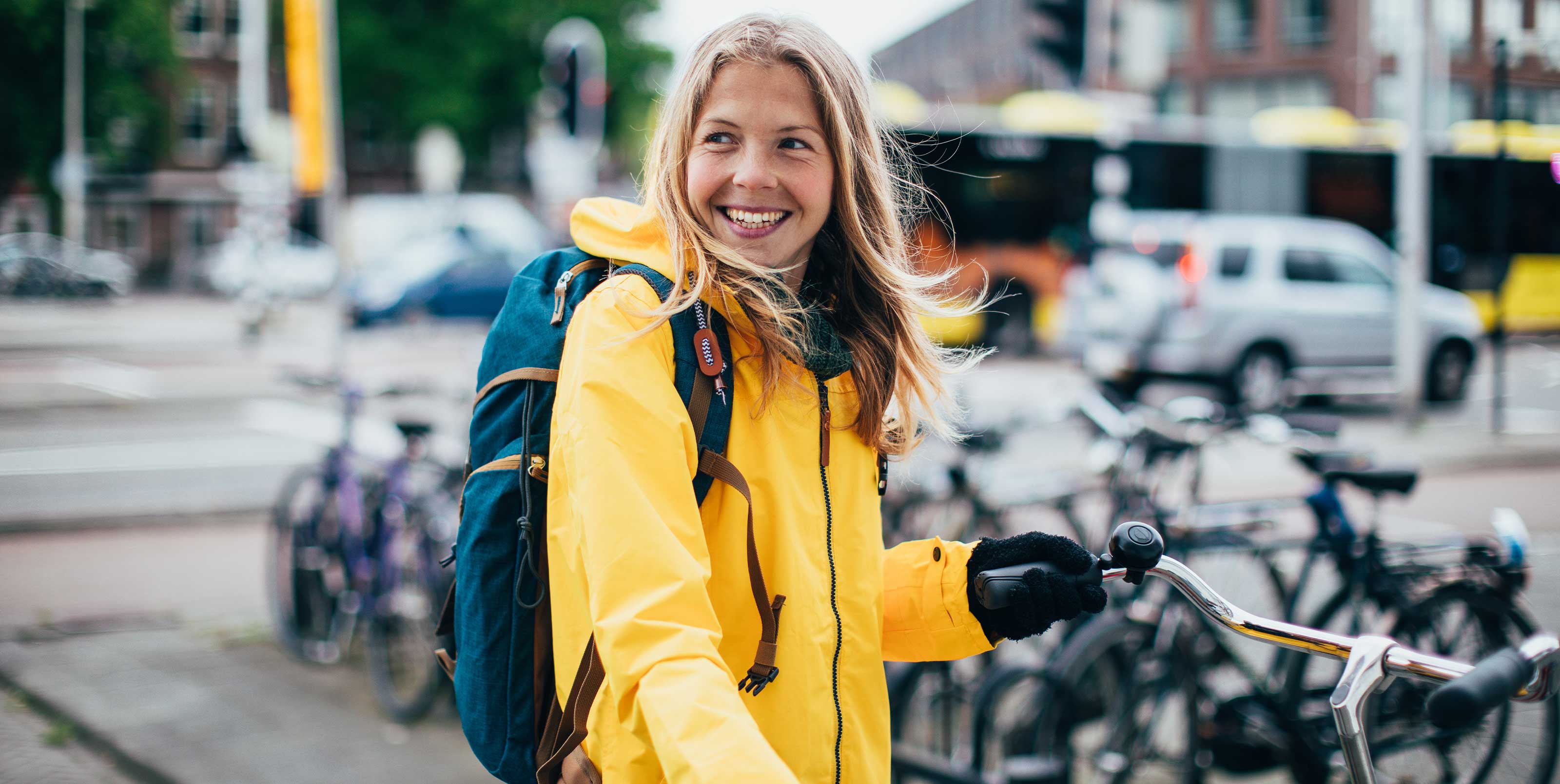 Smiling woman parking bicycle
