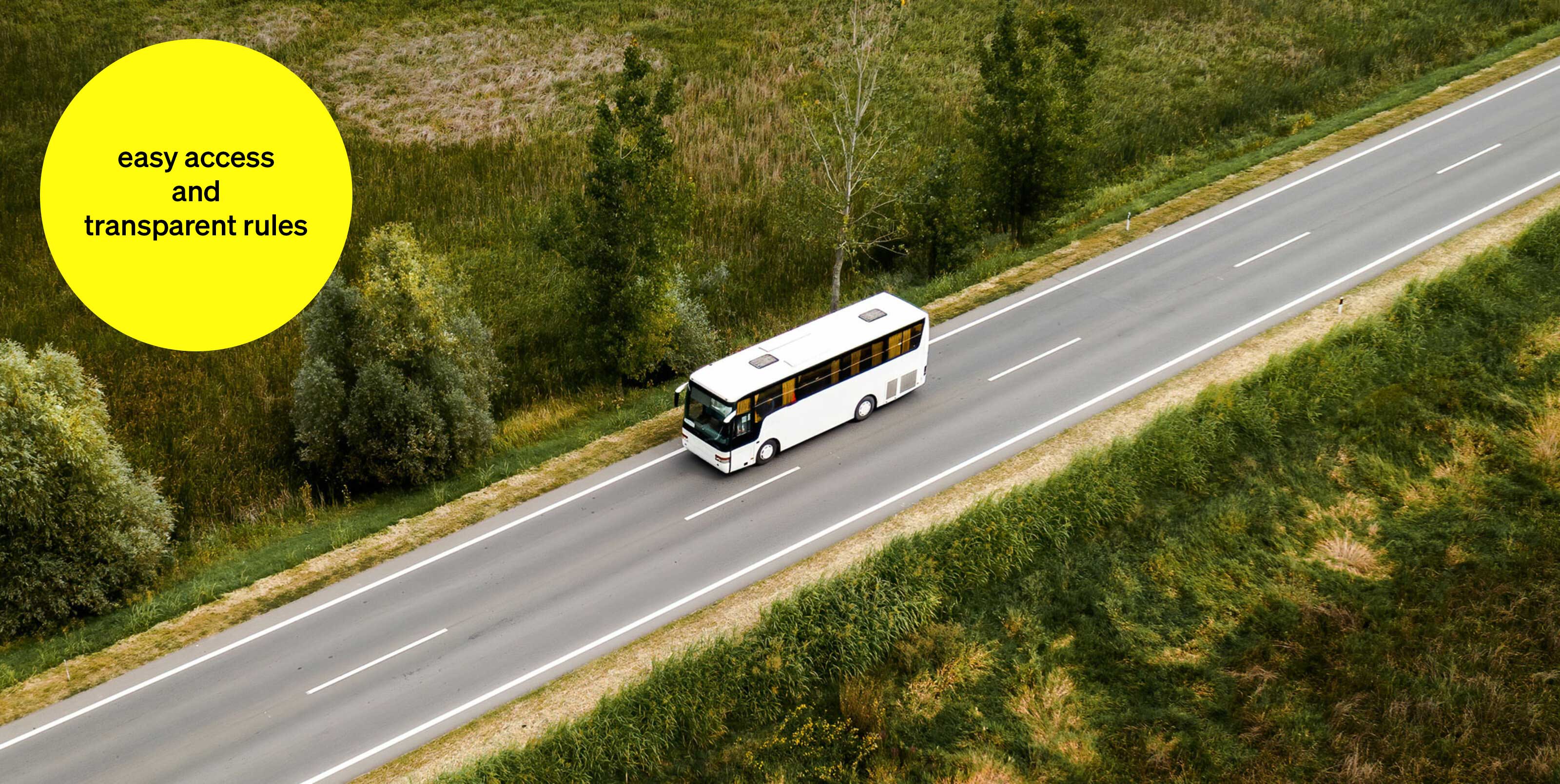 White bus driving on an open road through green landscape - text module in round tile: easy access and transparent rules